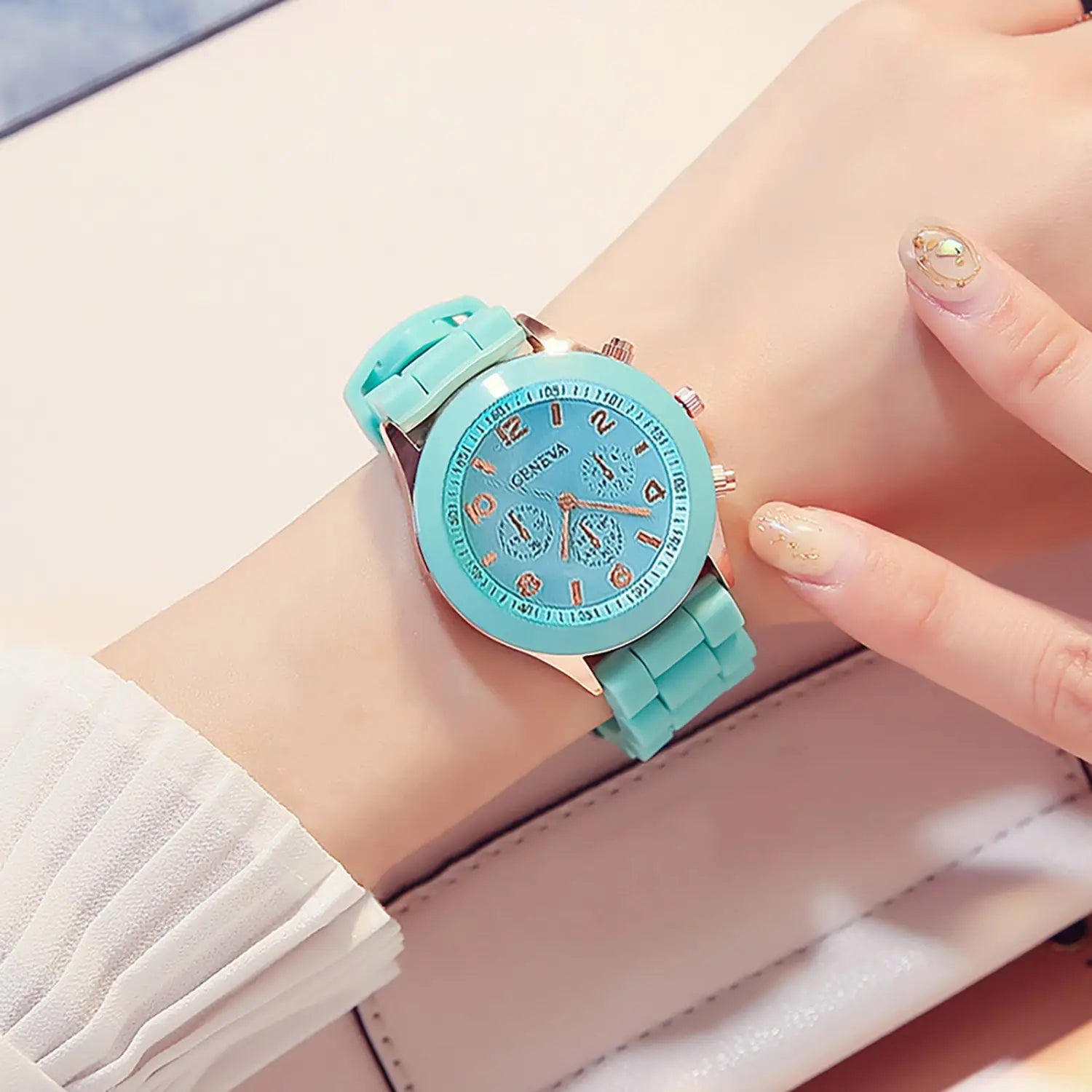 a women silicone quartz watch fashion chronograph with a turquoise silicone strap and matching face accented by rose gold tone details.