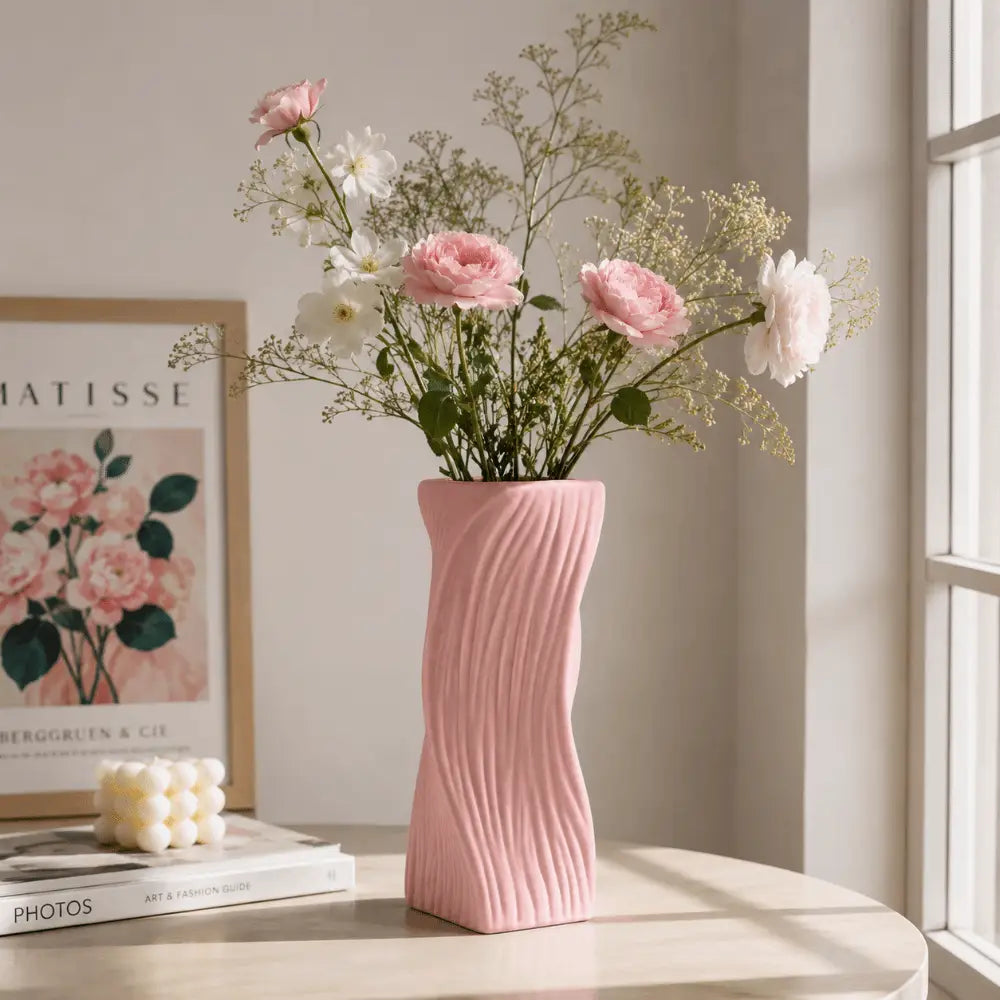 A soft pink Nordic wave plastic flower vase with a wavy ribbed texture holds an arrangement of delicate pink and white flowers for aesthetic home decor.