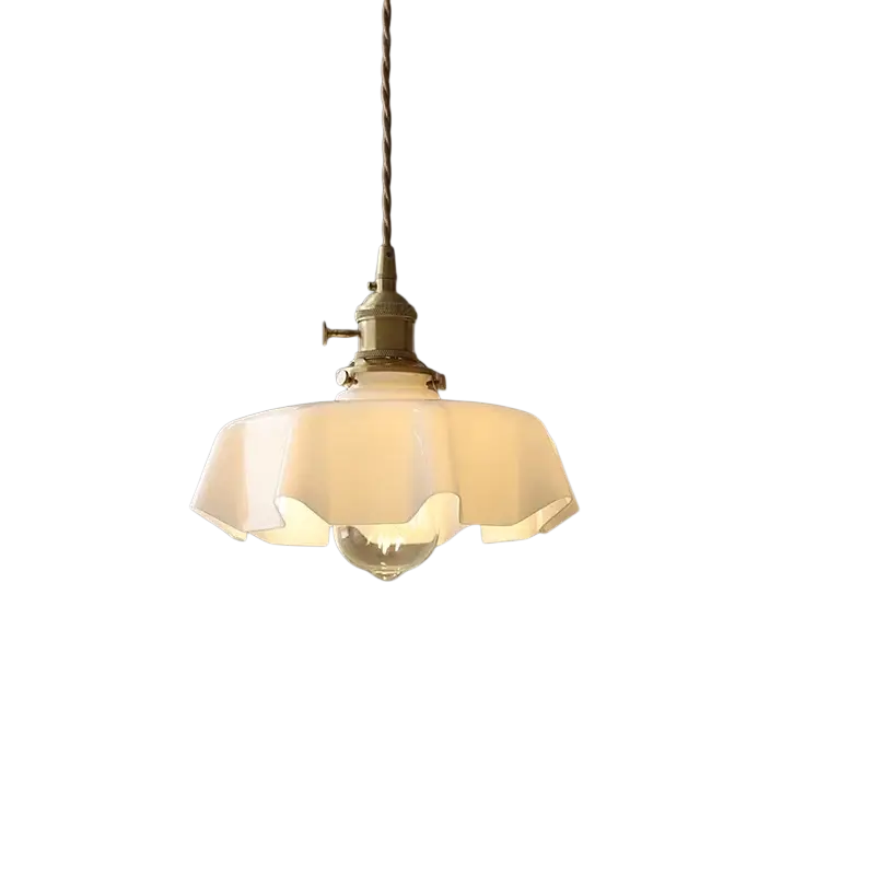 A cream-style ruffled glass flower skirt pendant light with brass fixture and twisted cord front view