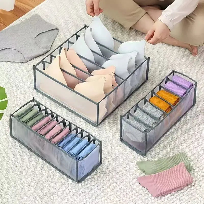 Organisateurs de lingerie en maille transparente avec des cadres en tissu gris tenant soigneusement des soutiens-gorge et des chaussettes pliés, de différentes couleurs, dans un séparateur de tiroir pour organisateur de sous-vêtements, boîte de rangement d’armoire 3 en 1.
