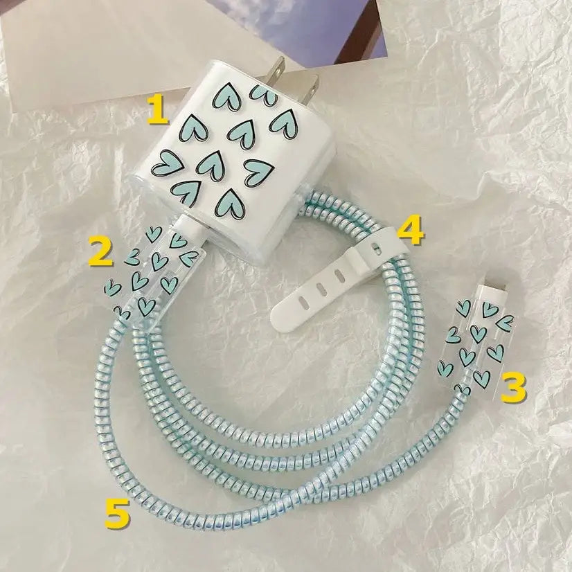 white heart-patterned iphone charger protector tpu wrap with coiled light blue cable and white clip in a 4 pack set
