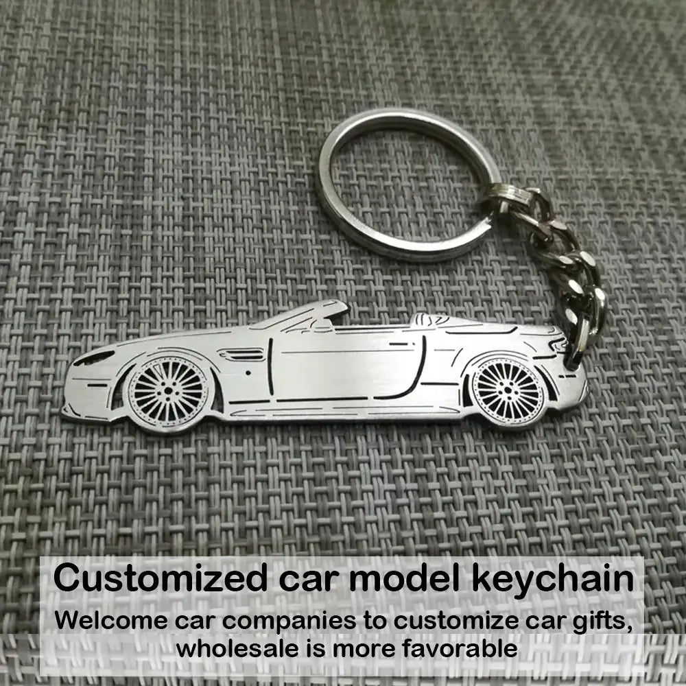 Silver metallic customized car model metal keychain shaped like a convertible sports car with detailed wheels and body lines.