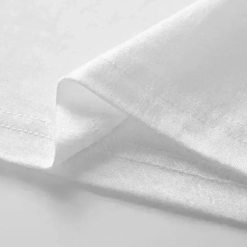 A graphic print oversized men short sleeve t shirt made of crisp white cotton fabric with a subtle textured weave and neatly stitched edges.