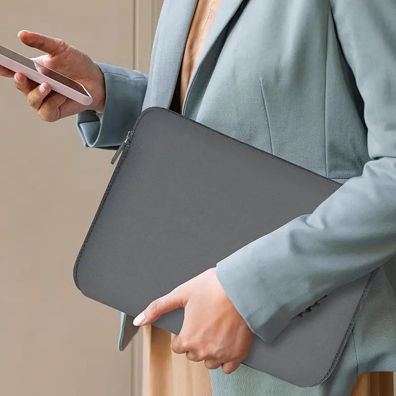 Gray neoprene laptop sleeve with sleek minimalist design and subtle edge stitching offering 360 degree protection case.
