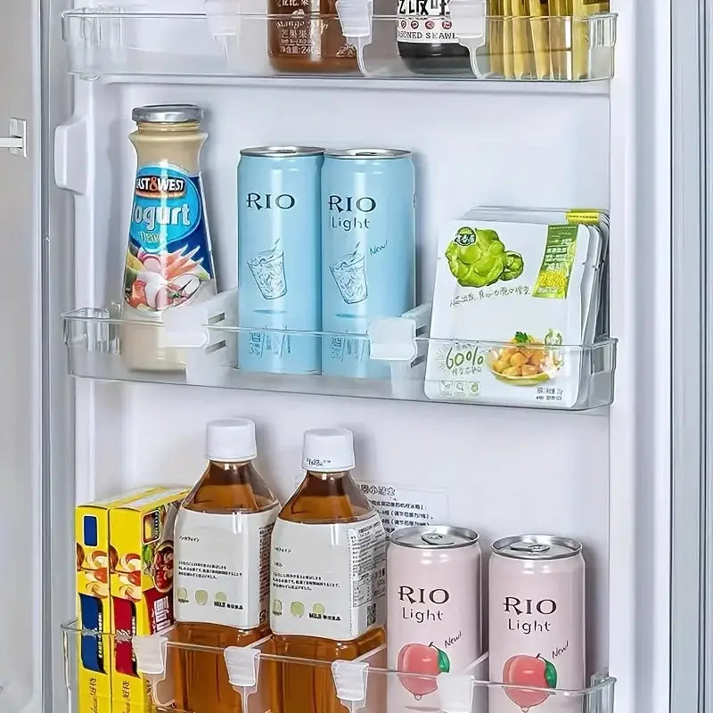 adjustable refrigerator space divider made of white plastic shown as clear plastic shelf organizers holding various beverages inside a refrigerator.