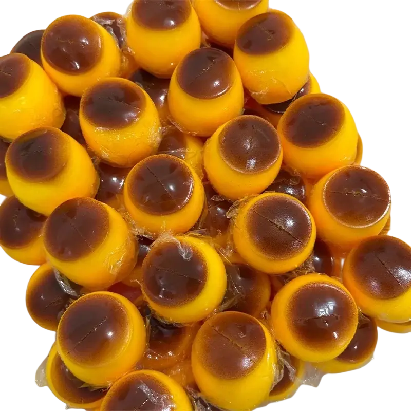Front view of yellow and brown layered jelly candies wrapped in clear plastic for caramel pudding stress ball toy