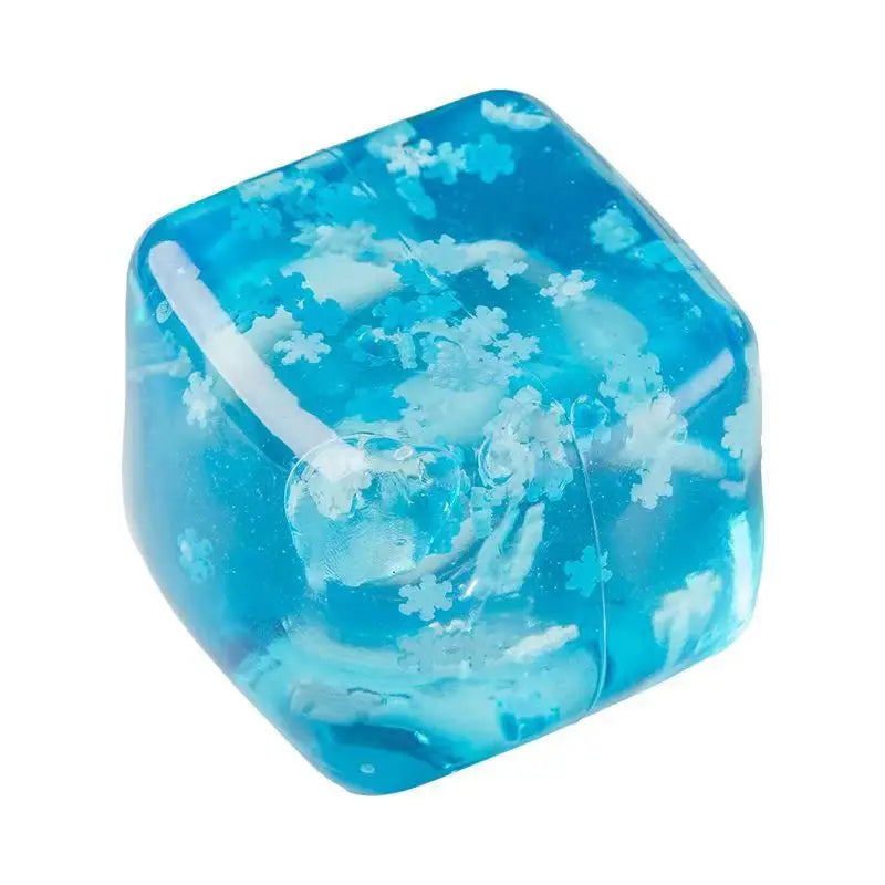 a translucent blue slow rising squishy sensory fidget toy shaped like ice cubes with embedded white snowflake patterns and a clear rounded button on one side