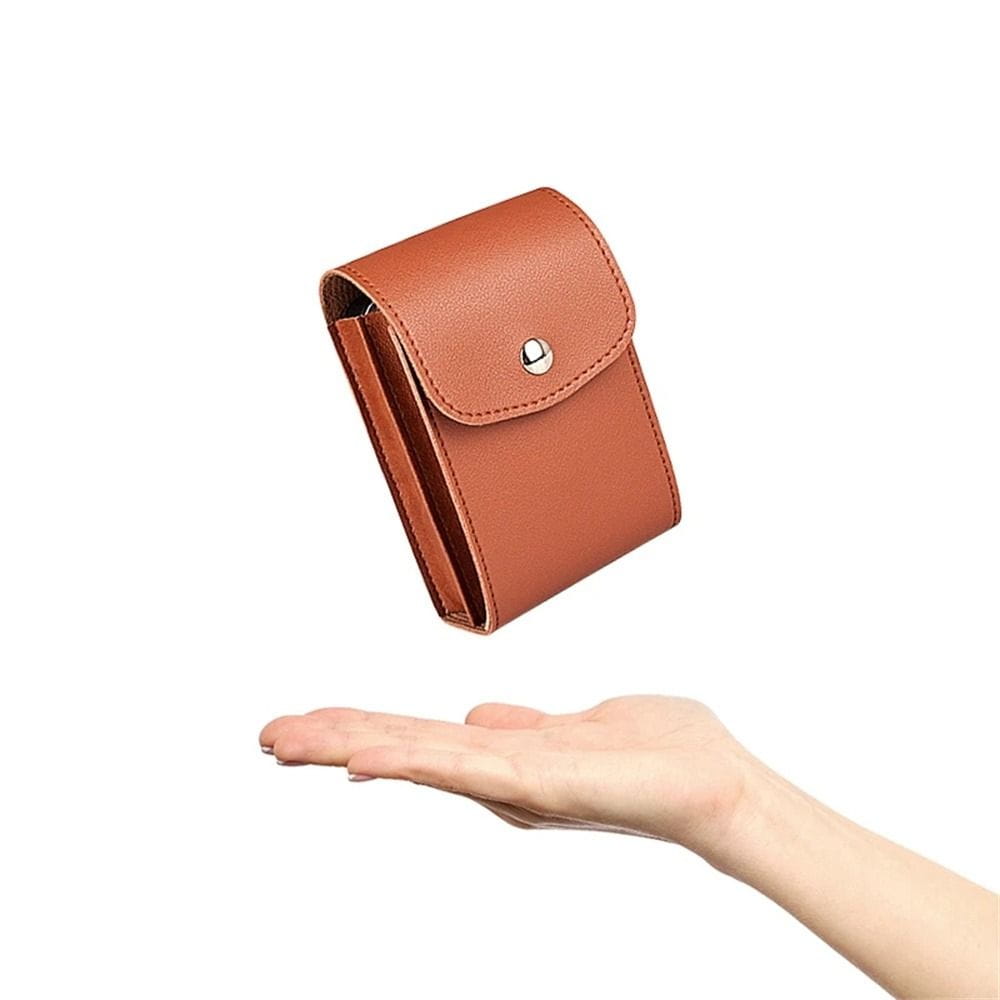 brown leather compact wallet made of pu leather with a silver snap button closure designed as a portable cable organizer for digital storage.