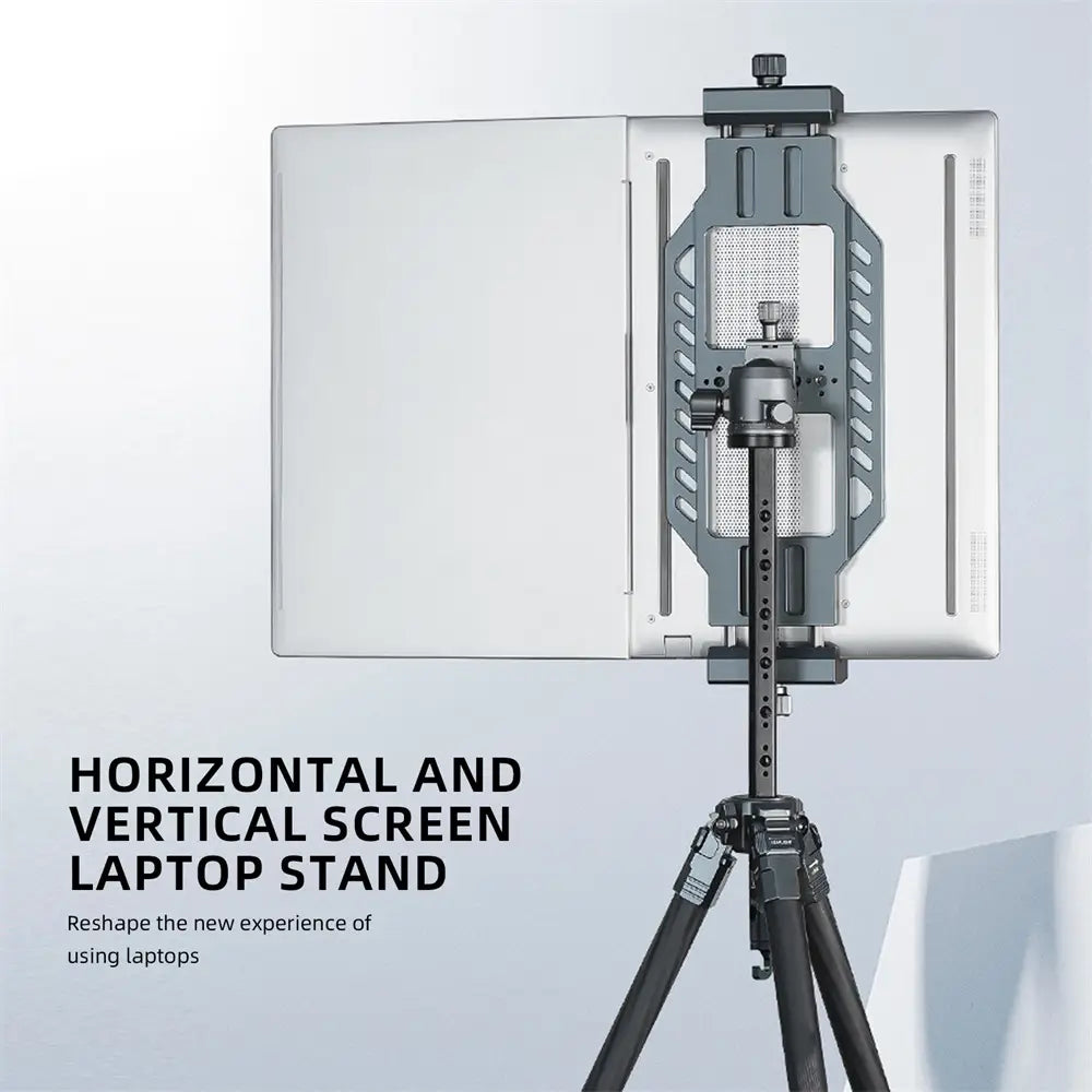 Silver aluminum vertical laptop stand with adjustable horizontal and vertical screen support mounted on a tripod.
