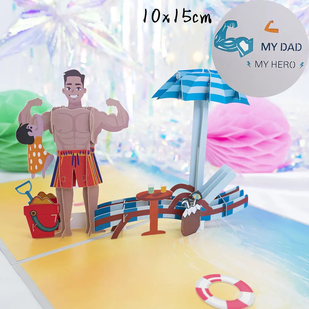 A colorful 3d pop up flower bouquet greeting card featuring a muscular father in red and yellow swim trunks holding his daughter on a detailed beach scene with an umbrella lounge chair bucket of sand and life preserver.