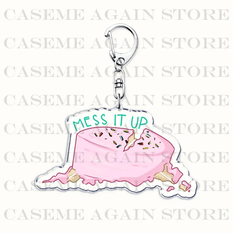 Pink frosted cake-shaped acrylic keychain with colorful sprinkles and mess it up in green lettering from the Gracie Abrams anime fan gift collection.