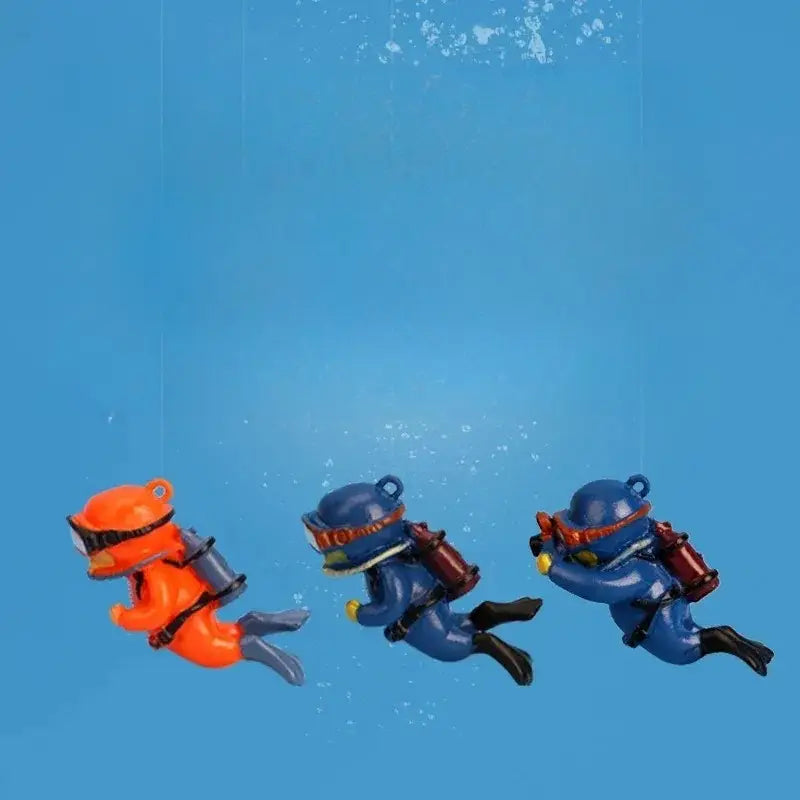 Three miniature scuba diver keychain figurines in orange with black, blue with red and yellow, designed as popular aquarium decorations for fish tanks landscape decor accessories and gifts for aquatic pets.