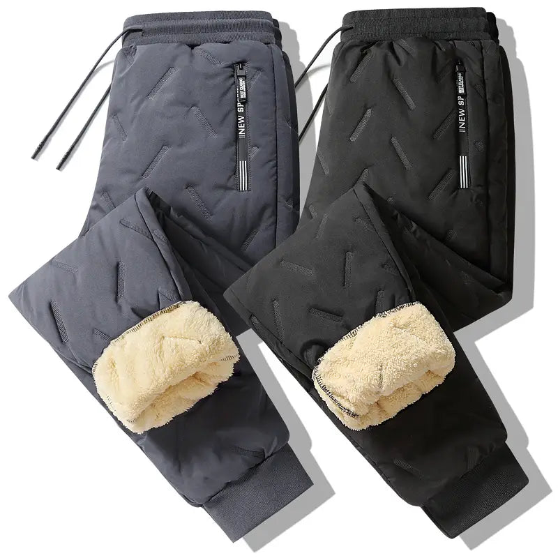 Men fleece lined thermal sweatpants in dark gray quilted fabric with plush beige fleece lining and black drawstring waistband designed for waterproof winter use.