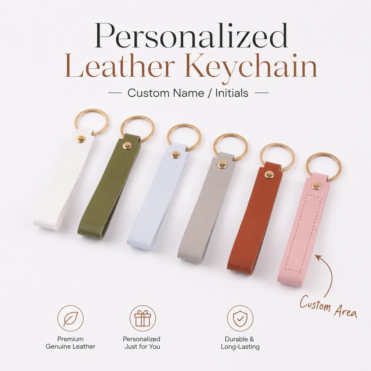 A set of six custom name leather keychains in white olive green light blue beige brown and pink featuring gold-toned rings and stitched areas for engraving.