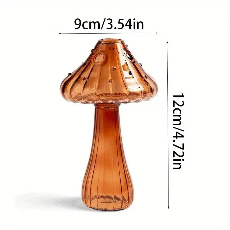 A translucent amber glass mushroom-shaped bud vase with a ribbed stem and dotted cap designed as a colorful Nordic plant holder.