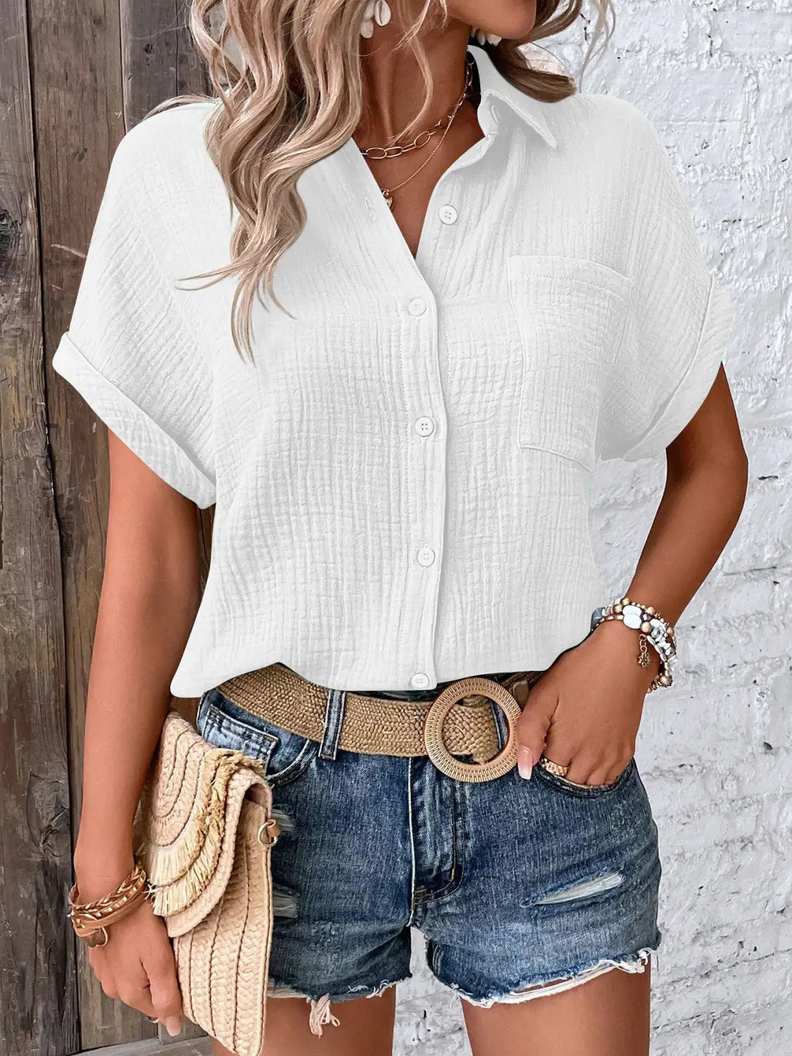 Women cotton short sleeve button up shirt in white with a subtle crinkled textured fabric finish.