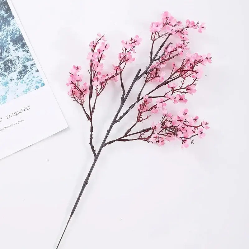 a delicate artificial flowers cherry branch with soft pink blossoms and dark brown stems in an artificial flowers cherry blossoms bouquet pink
