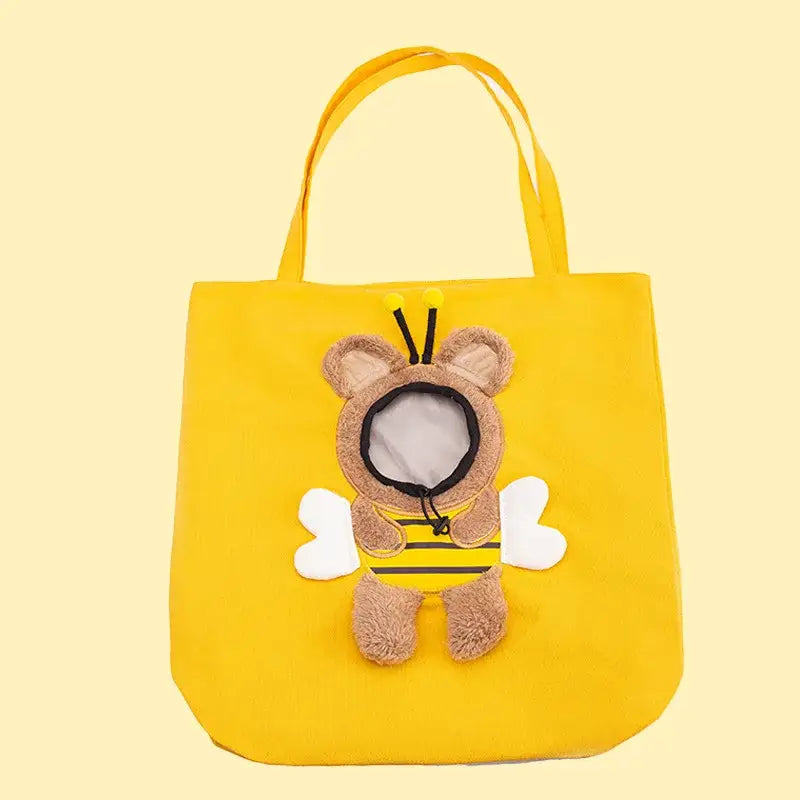 Bright yellow canvas pet carrier bag featuring a plush fuzzy brown bear dressed as a bee with white wings and black antennae suitable for small dogs and cats with mouth length access.