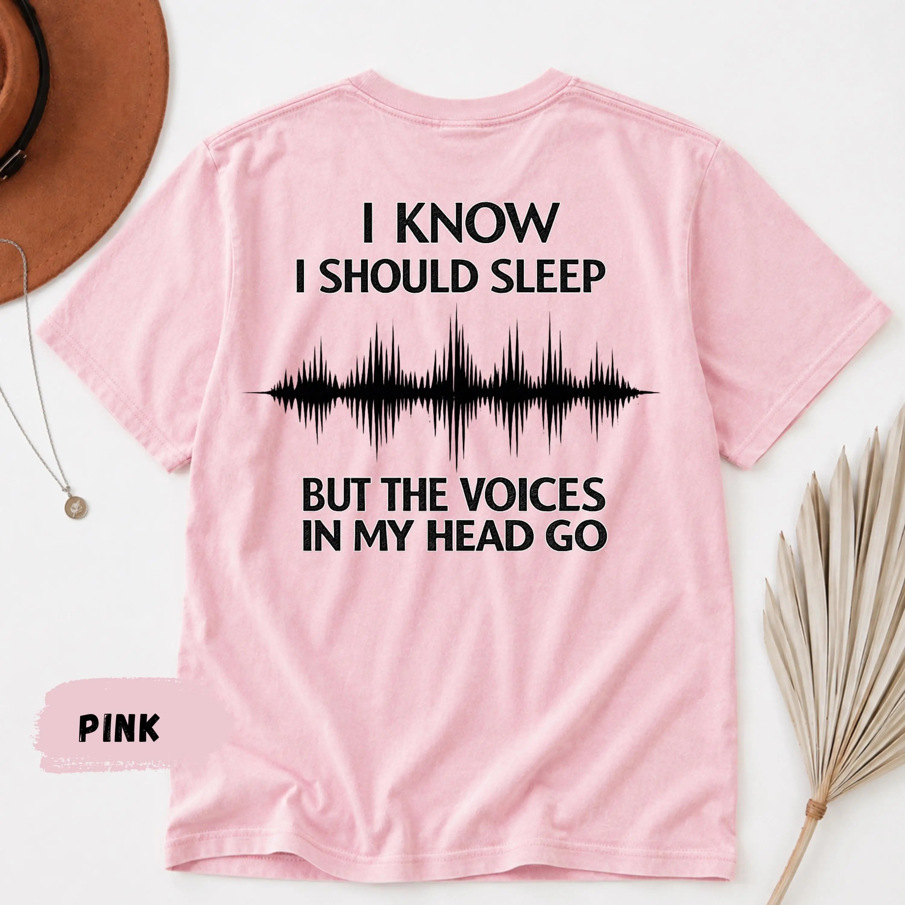 Pink short-sleeved cotton t-shirt showing the back side with black text and a soundwave graphic from the funny insomnia graphic tshirt dark humor sleep tee collection.