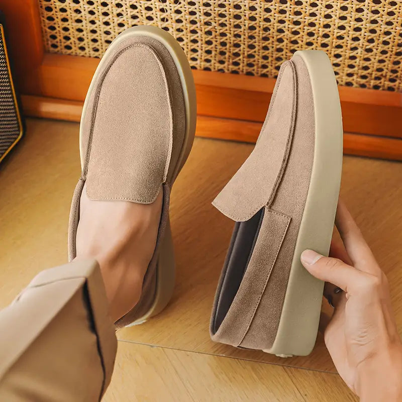Beige suede slip-on loafers for men with a thick off-white rubber sole designed for casual walking.