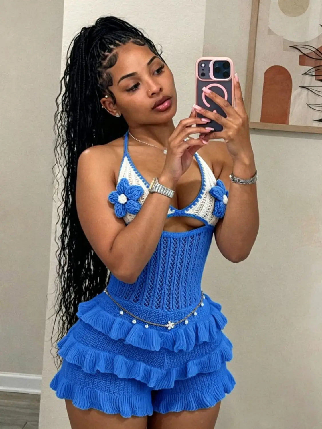 Blue crocheted knitted ruffle halter romper summer playsuit with white floral accents and a ruffled skirt.
