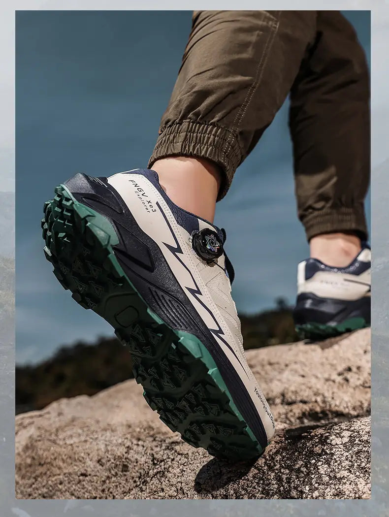 Men hiking shoes waterproof lightweight trekking sneakers in beige and navy blue with a green rubber outsole and black toggle closure system.