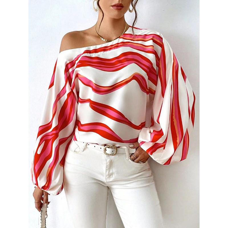 A vibrant slash neck off shoulder satin blouse with bold wavy stripes in shades of red and pink on a white fabric featuring an elegant sleeve style.