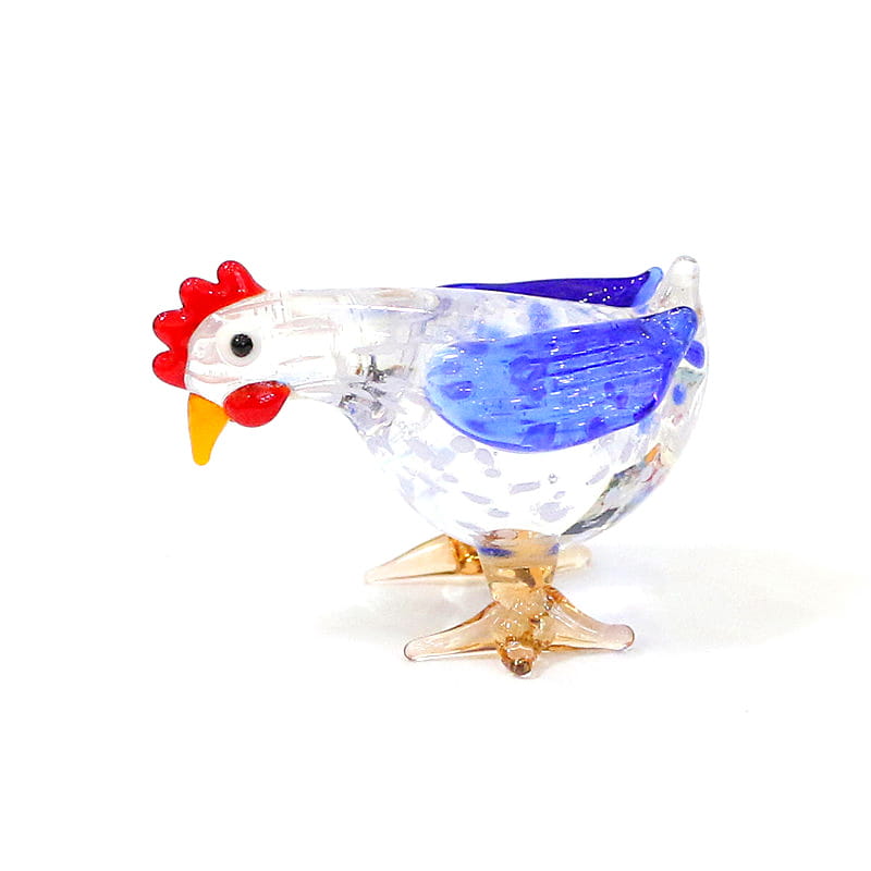 A translucent glass rooster miniature figurine with a red comb and wattle blue wing accents and amber-colored feet used as an Easter ornament.