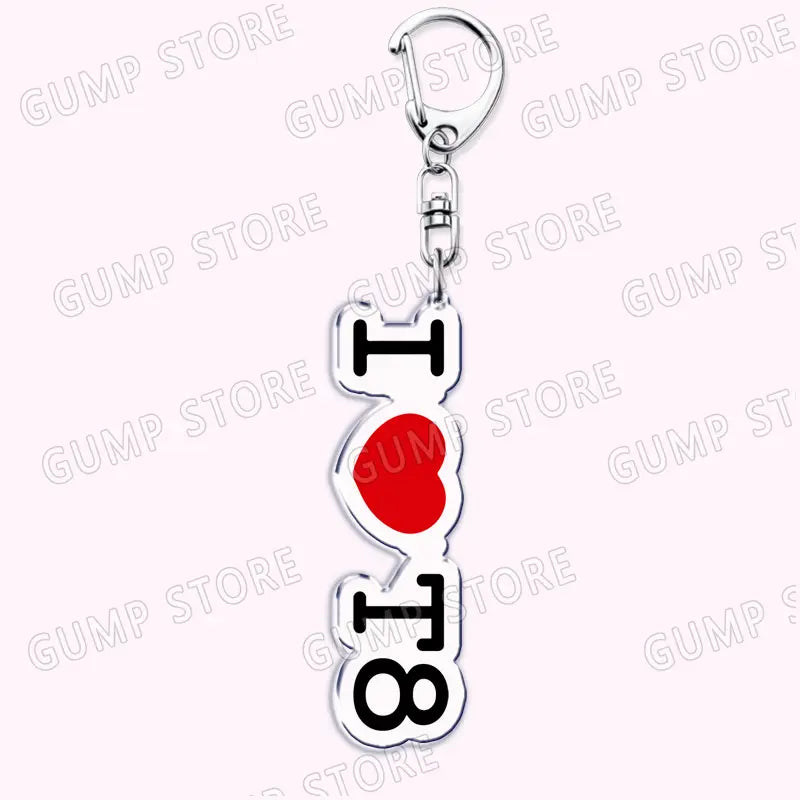 Silver-colored acrylic keychain featuring a vertical design with black lettering and a red heart symbol spelling i heart 8 for Tate Mcrae music fan gift.