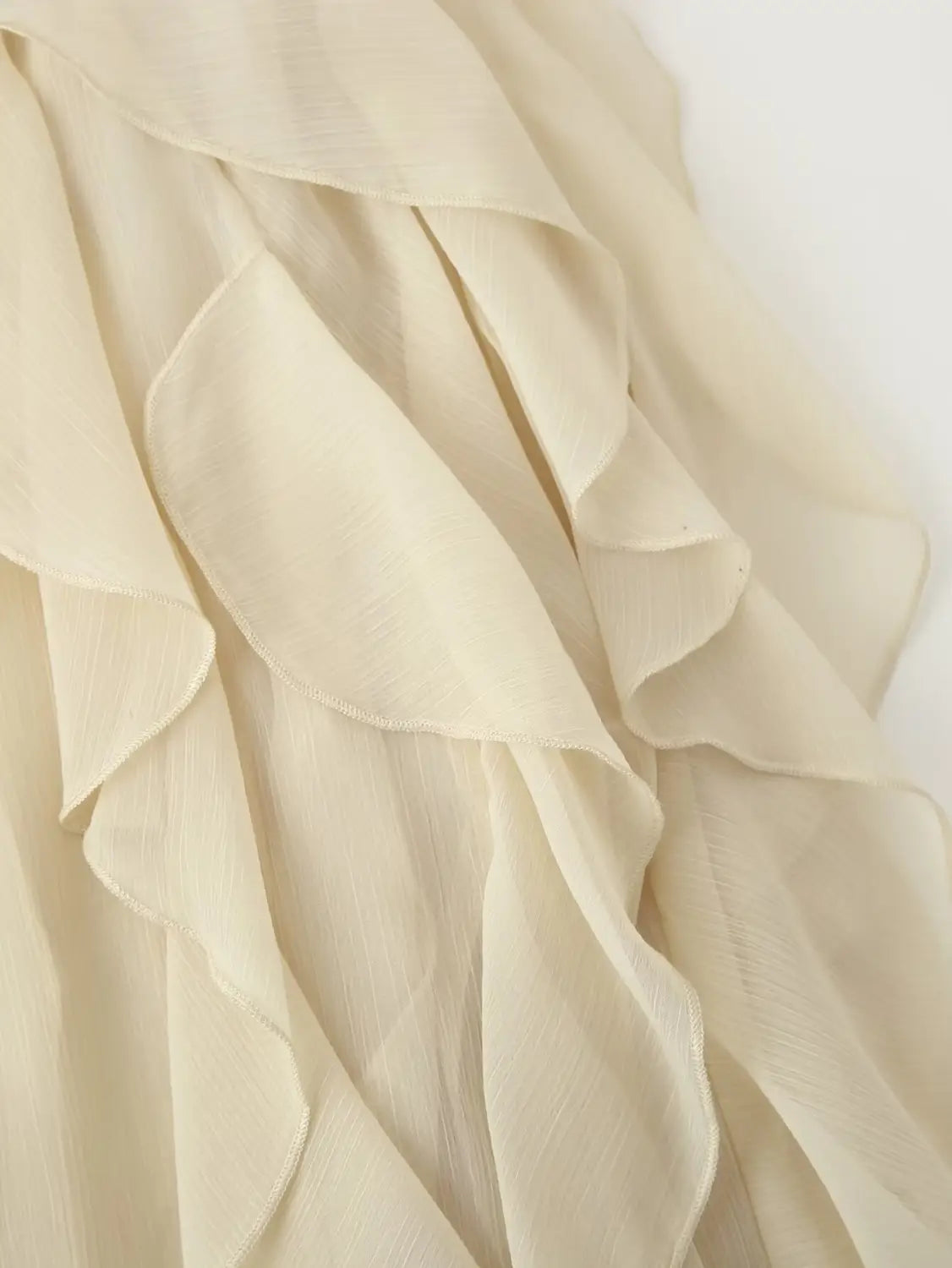 cream-colored chiffon ruffle shirt long sleeve with layered, soft flowing texture and v-neck design