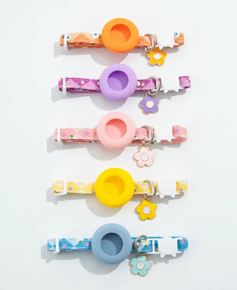 a set of five colorful silicone airtag cat collars with matching circular rings and floral charms featuring an airtag protective case suitable for outdoor park dog and park dog cat use