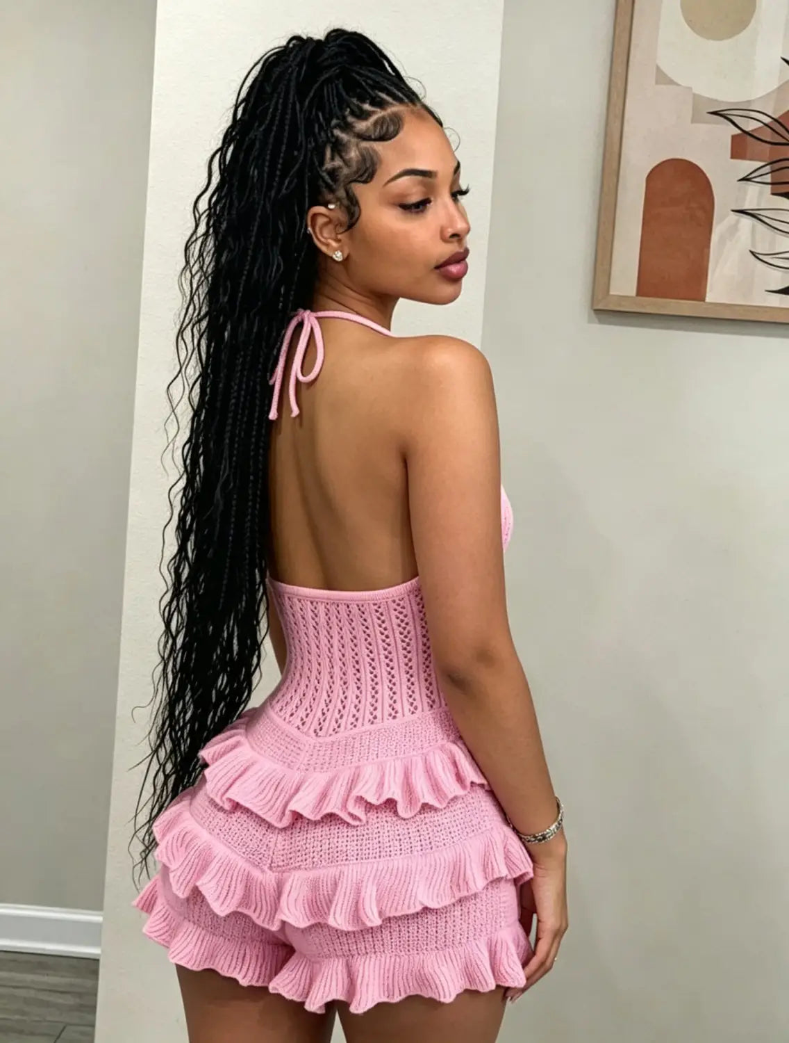 Pink knitted two-piece summer playsuit with ruffled layers and halter neckline.