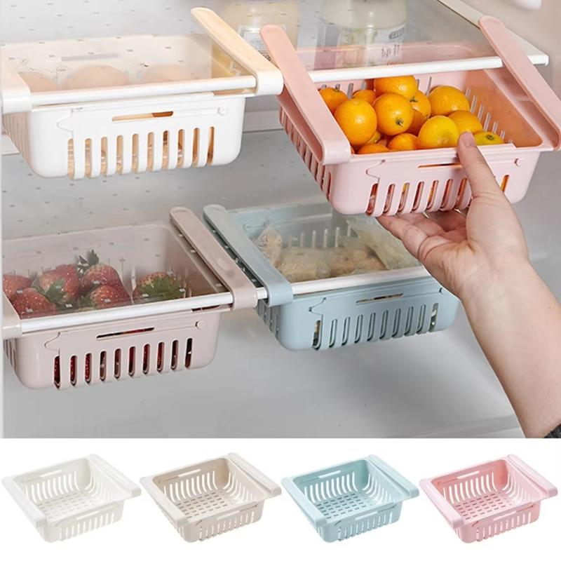 pastel-colored plastic drawer organizers made of food-grade polypropylene with slatted sides and integrated handles for storing fruits or vegetables in an adjustable sink drain rack kitchen shelf.
