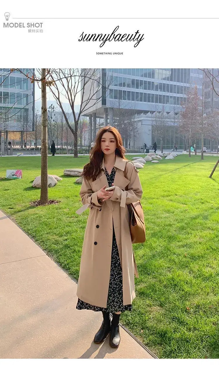 Beige women double-breasted trench coat with classic black buttons designed as a casual windbreaker.