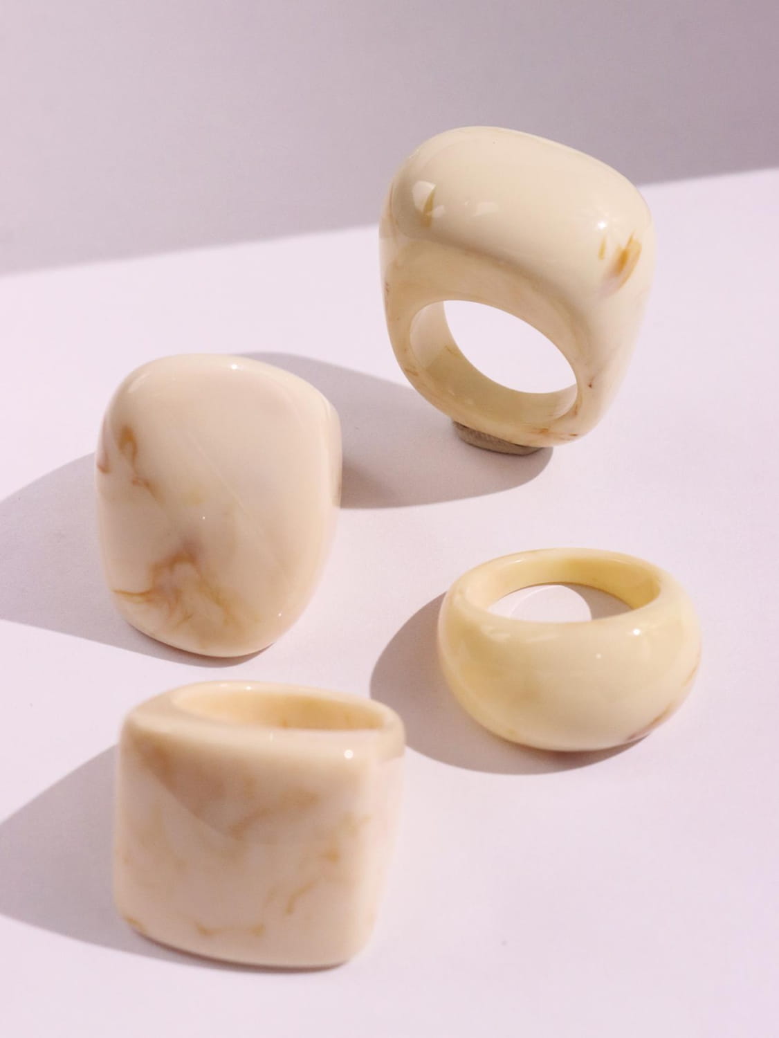 Cream-colored chunky resin cocktail rings 4-piece set featuring smooth texture, subtle marbled patterns, and rounded edges.
