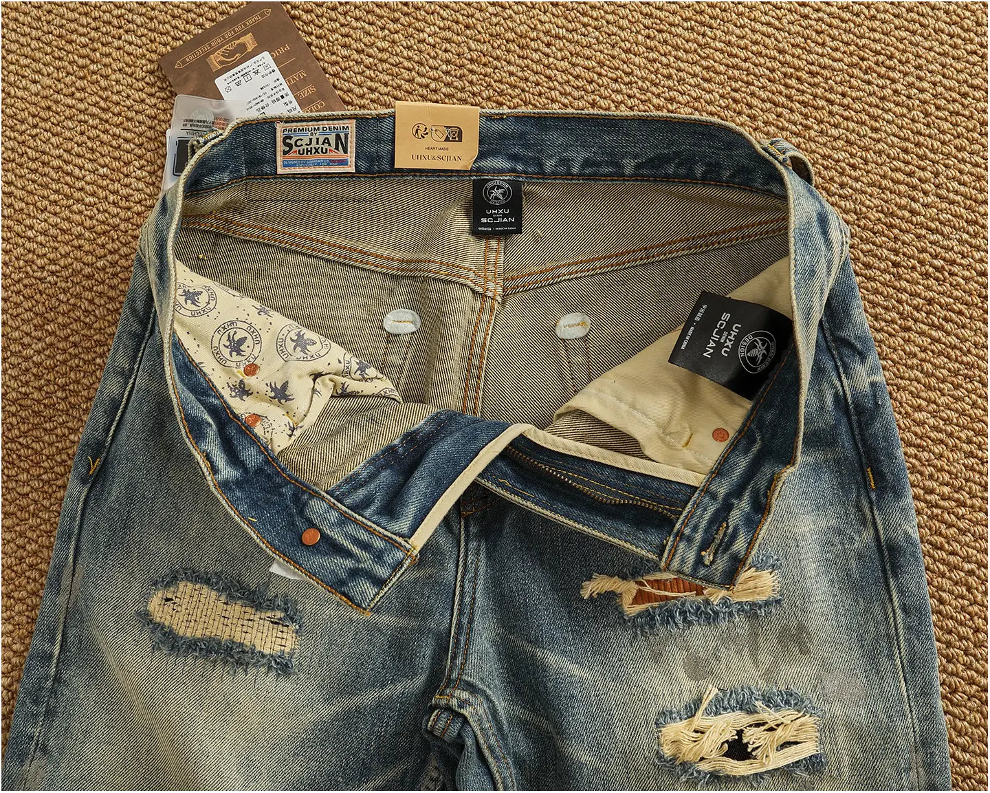 Distressed patchwork denim jeans men featuring distressed blue denim with a faded wash frayed patches visible stitching and branded tags.