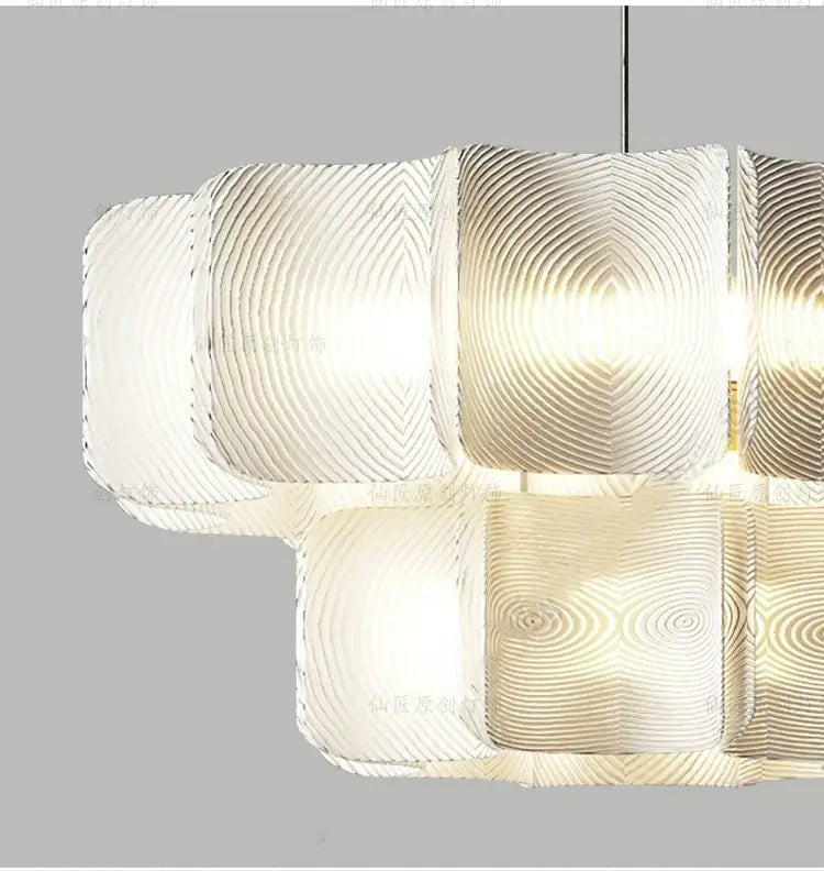 Minimalist wabi sabi led chandelier pendant light featuring a modern geometric design with translucent ripple patterned glass panels arranged in a staggered formation.