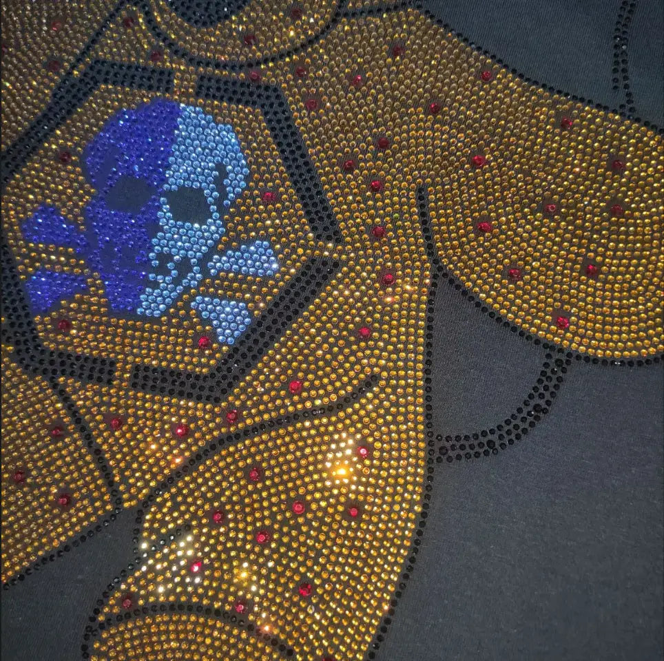 Men rhinestone devil bear graphic tee featuring a gold rhinestone-embellished hoodie with a blue and purple skull design and red accent stones.