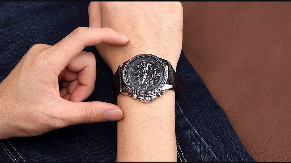 Megir 1010 men quartz chronograph watch with a sleek black dial, silver-toned case, multiple subdials, red accent details, and a dark leather strap.