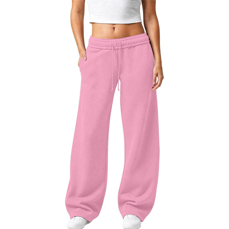 ピンクのワイドレッグスウェットパンツ。無地デザインで、ドローストリング付きウエストバンドとサイドポケットを備えたカジュアルな着用向け。