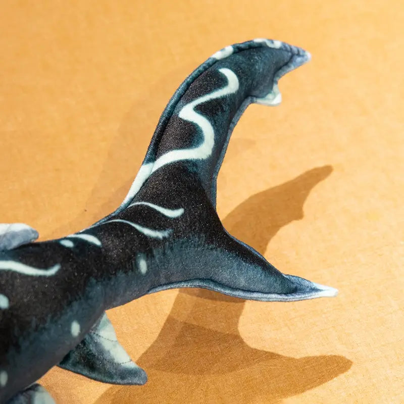 hammerhead shark plush pillow soft toy showing black and white patterned shark tail with textured fabric.