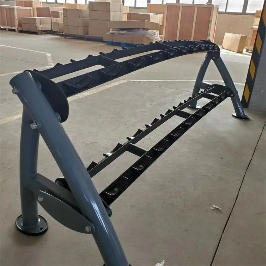 Gray metal commercial 2-tier dumbbell rack with black plastic inserts for securely holding weights.