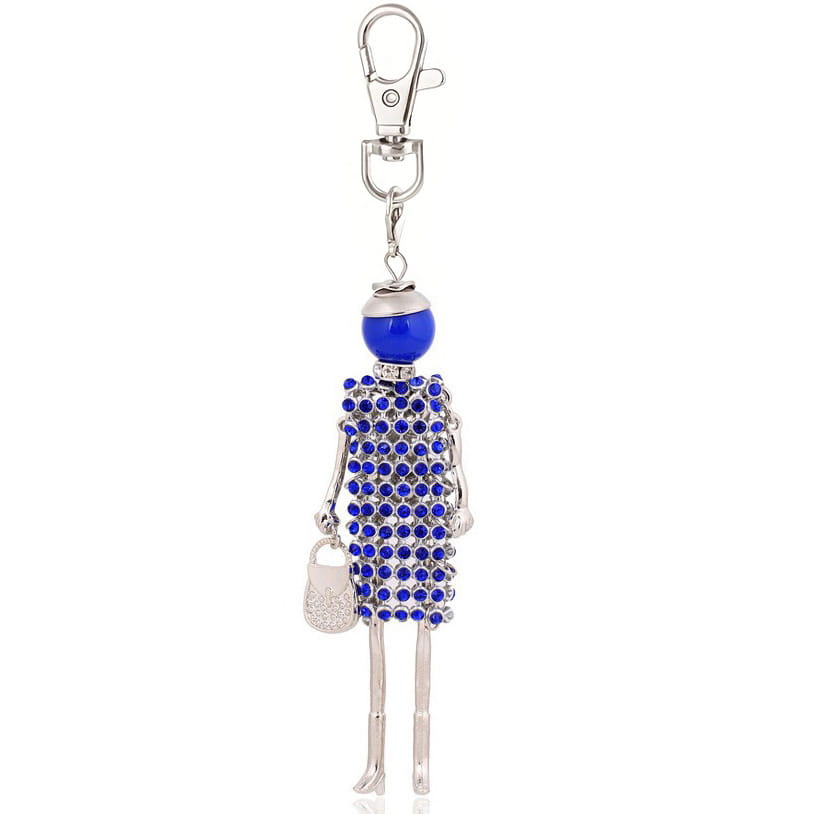 A blue rhinestone-encrusted doll keychain with a silver-toned metal body holding a small glittery purse designed as a women bag pendant.