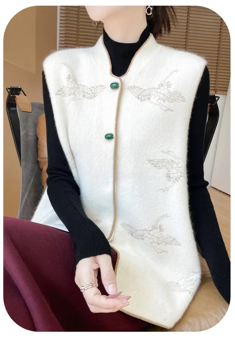 White wool knit vest for women featuring silver angel embroidery and emerald green buttons.