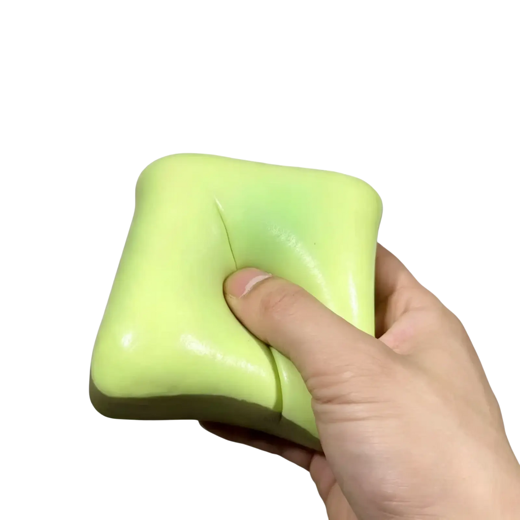 A soft lime green square bread butter slow rising squishy stress ball with smooth glossy surface for stress relief