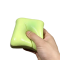 A soft lime green square bread butter slow rising squishy stress ball with smooth glossy surface for stress relief