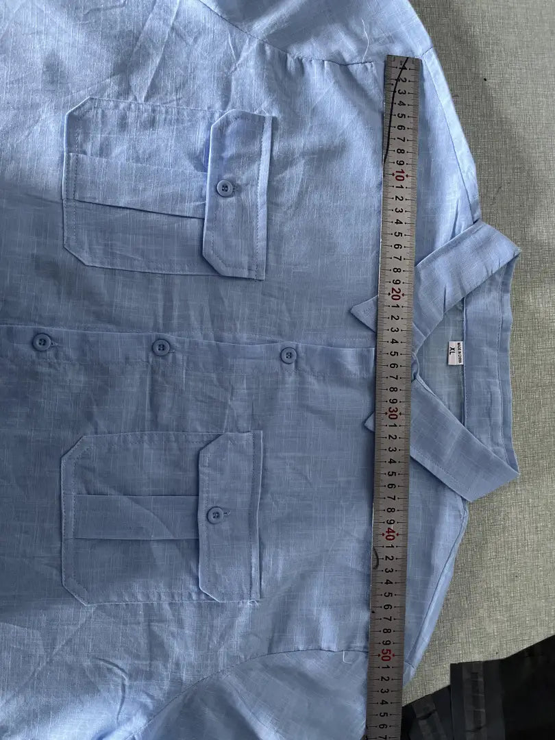 Light blue men linen short sleeve shirt with double chest pockets and a collar designed for casual summer wear.