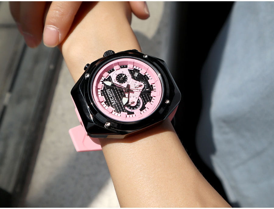 A bold black and pink Megir sport chronograph watch featuring a skeletonized dial design with a matte-finish case and matching silicone strap.