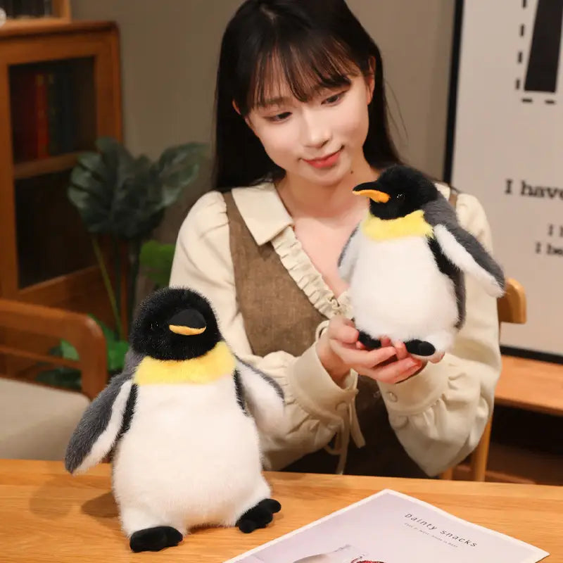 soft plush penguin stuffed animal toys with black white and yellow accents designed as a soft toy pair.