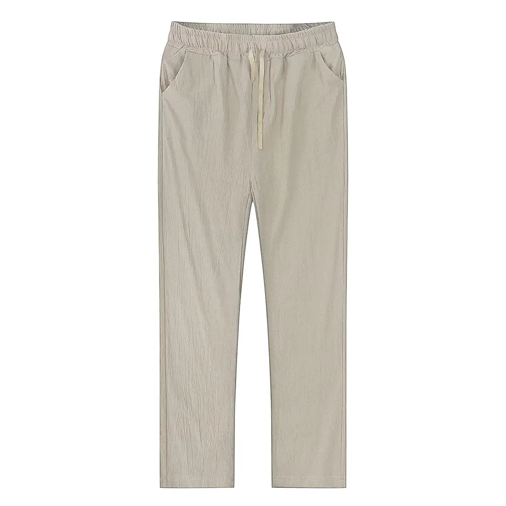 Beige cotton linen trousers with breathable fabric, relaxed fit, drawstring waist, and subtle vertical texture for casual wear.